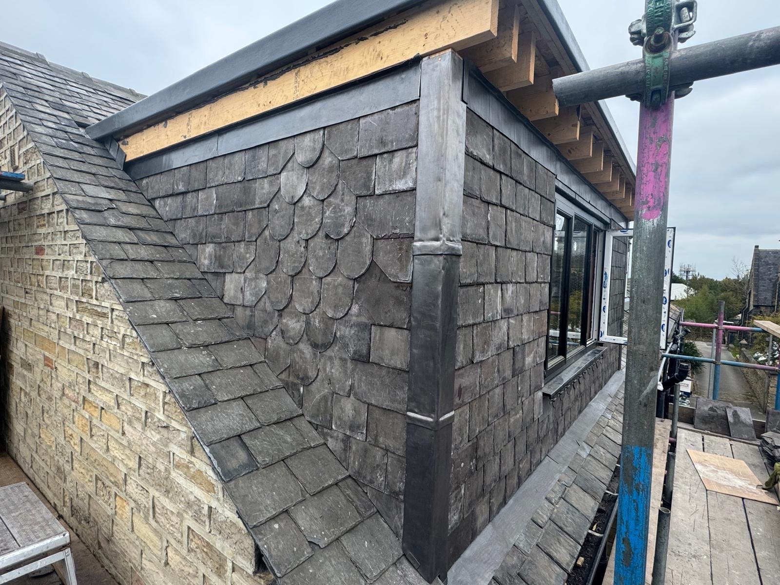 Slate-clad dormer with windows and decorative slate detailing in Pudsey