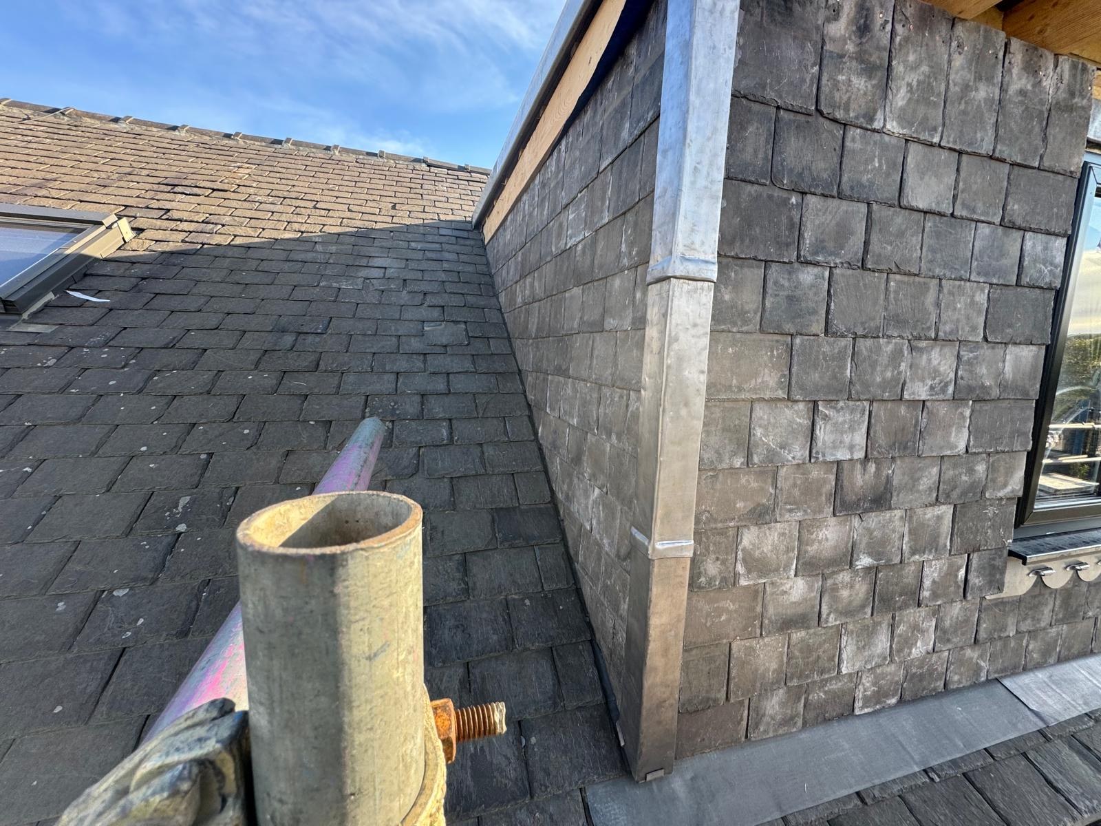 Lead flashing at the base of a slate-clad dormer cheek