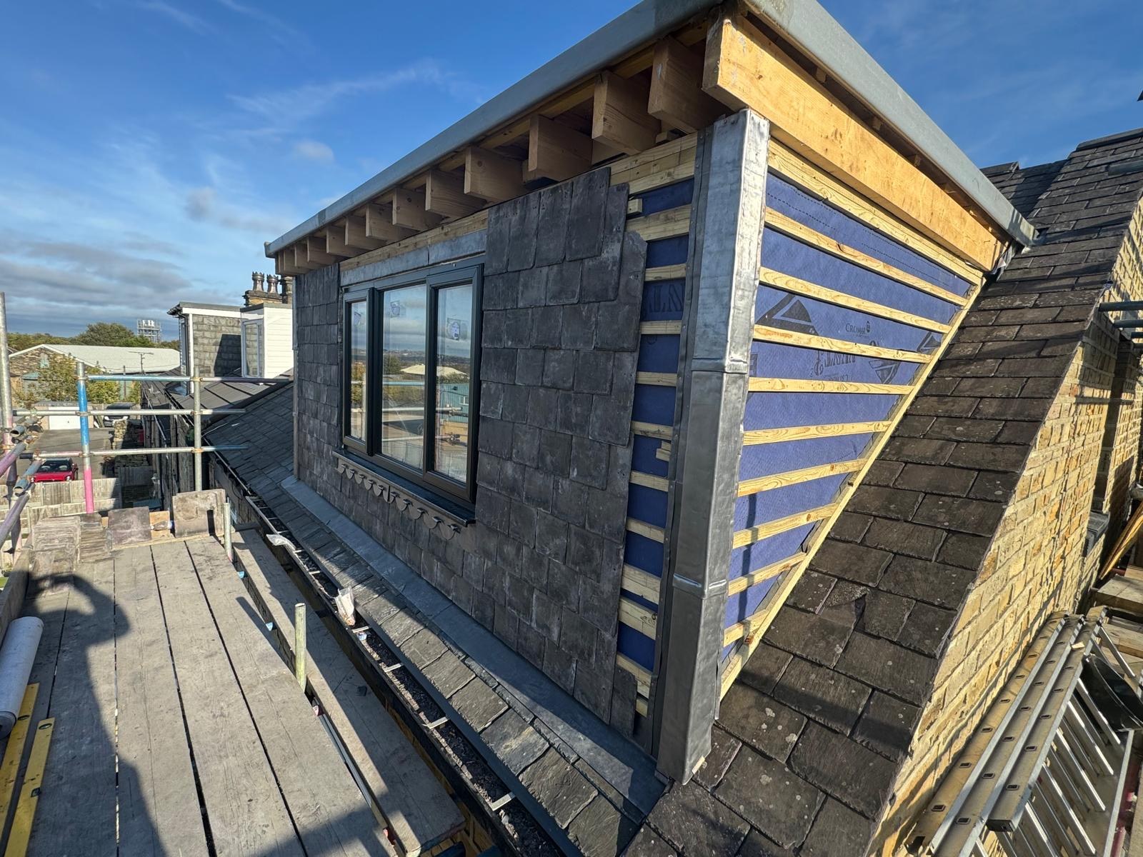 Dormer front with windows and an adjoining cheek at the membrane and batten stage
