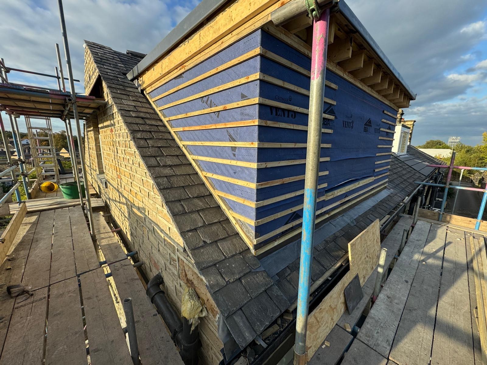 Another view of the dormer cheek membrane and battens beside the slate roof