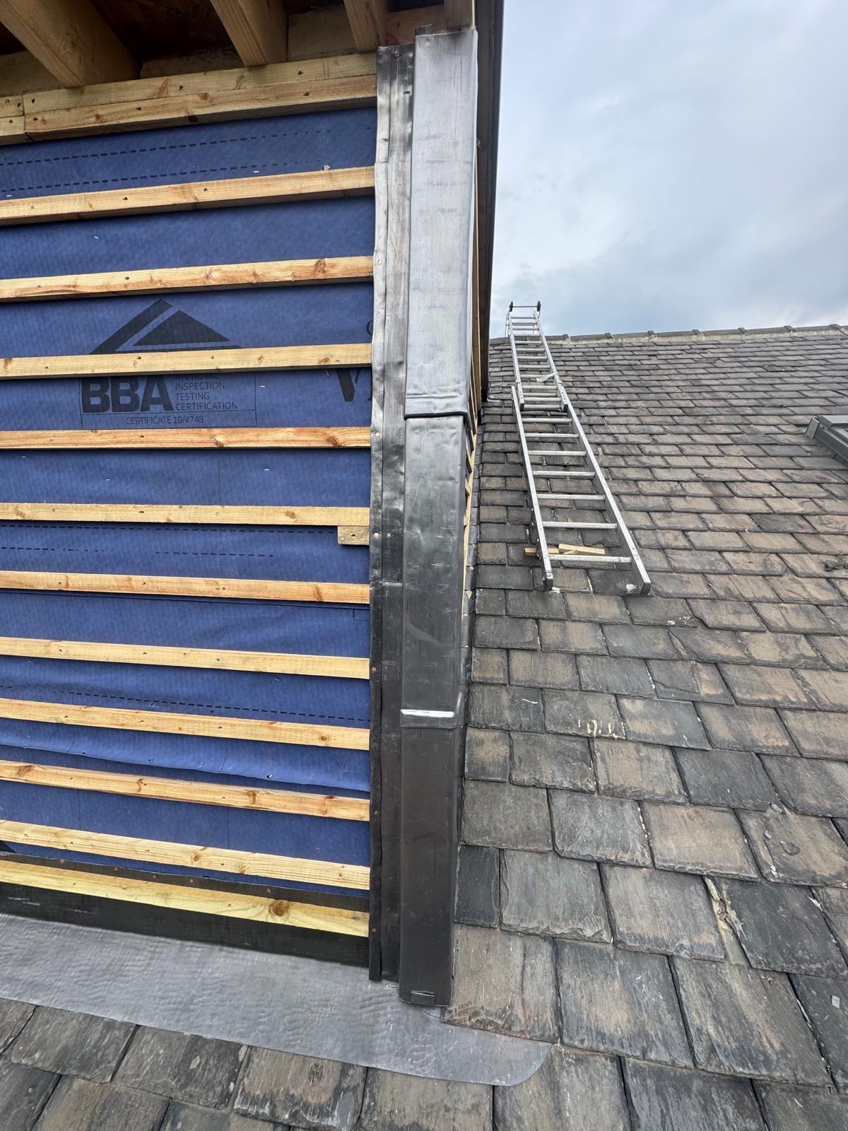 Close view of a window-side junction, membrane, battens and leadwork