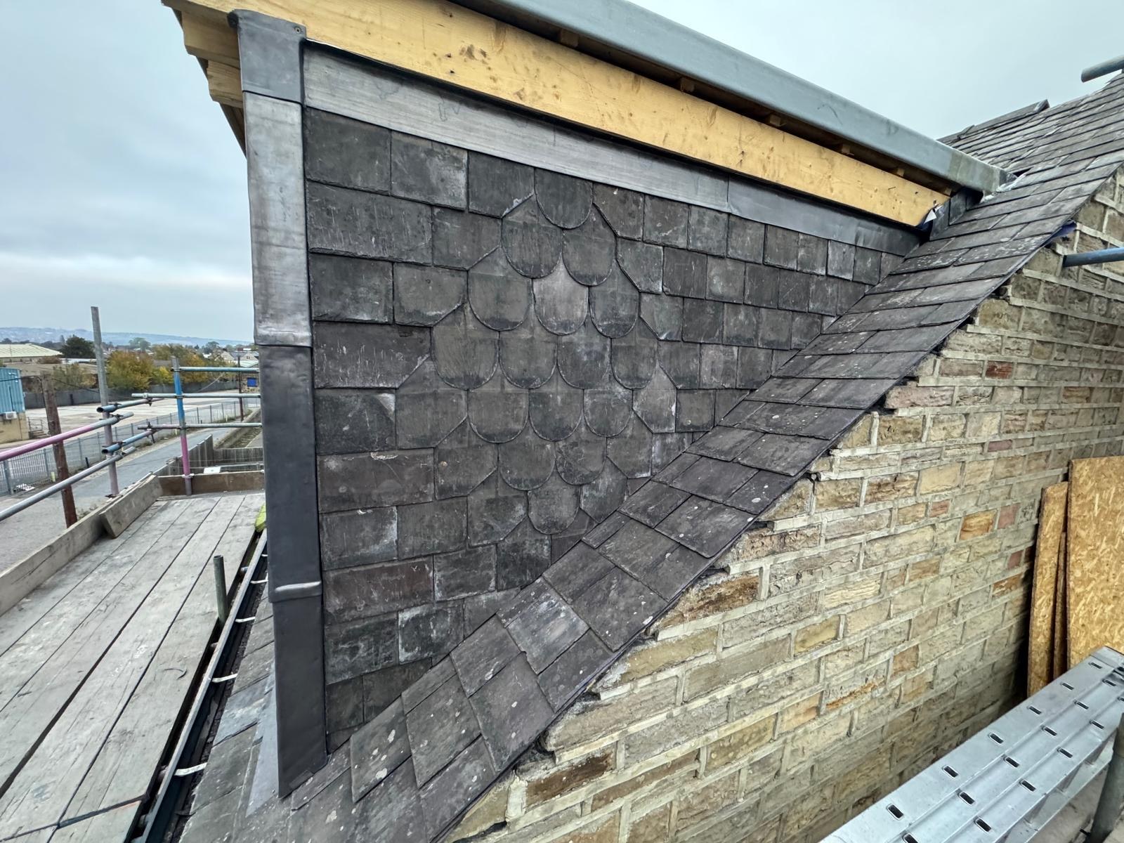 Slate cladding and leadwork on a dormer cheek with unfinished upper trim